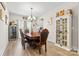 Spacious dining room featuring an elegant table, modern chandelier, and a chic cabinet with wine storage at 2704 Watergarden St, York, SC 29745