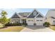 Charming two-story home featuring blue and gray siding, a two-car garage, and a well-manicured front yard at 2704 Watergarden St, York, SC 29745