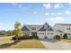 Charming two-story home featuring blue and gray siding, a two-car garage, and a well-manicured front yard at 2704 Watergarden St, York, SC 29745