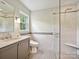 Modern bathroom featuring a glass shower, tiled walls, and a sleek vanity at 301 Glen Oaks Rd, Charlotte, NC 28270