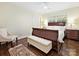 Comfortable bedroom with a wooden bed frame, plush linens, and hardwood floors at 301 Glen Oaks Rd, Charlotte, NC 28270