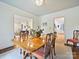 Open-concept dining room with hardwood floors and views into other living areas at 301 Glen Oaks Rd, Charlotte, NC 28270