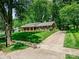 Charming brick home with a well-manicured front lawn and a long driveway lined with trees at 301 Glen Oaks Rd, Charlotte, NC 28270