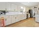 Bright kitchen with white cabinets, modern countertops and stainless steel appliances at 301 Glen Oaks Rd, Charlotte, NC 28270