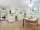 Eat-in kitchen features laundry room, white cabinets, and modern lighting at 301 Glen Oaks Rd, Charlotte, NC 28270