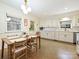 Eat-in kitchen features white cabinets, modern lighting, and large windows at 301 Glen Oaks Rd, Charlotte, NC 28270