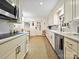 Updated kitchen with stainless appliances and ample counter space overlooking the dining area at 301 Glen Oaks Rd, Charlotte, NC 28270