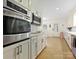 Well-equipped kitchen with stainless appliances, white cabinets, and a bright, inviting atmosphere at 301 Glen Oaks Rd, Charlotte, NC 28270