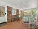 Cozy brick porch with seating and view to the backyard at 301 Glen Oaks Rd, Charlotte, NC 28270