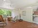 Bright screened porch featuring comfortable seating and views of the surrounding greenery at 301 Glen Oaks Rd, Charlotte, NC 28270