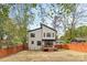 Modern home featuring a spacious backyard with a wood fence, deck, and green landscaping at 3256 Brixton Ct, Charlotte, NC 28205