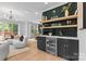 Elegant bar area with a wine fridge, open shelving, and a view of the living space at 3256 Brixton Ct, Charlotte, NC 28205