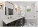 Modern bathroom featuring double sinks, gold fixtures, and black and white patterned tile flooring at 3256 Brixton Ct, Charlotte, NC 28205