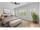 Bright bedroom featuring a ceiling fan, neutral decor, and ample natural light from the surrounding windows at 3256 Brixton Ct, Charlotte, NC 28205