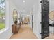 Bright entryway with wood floors, a decorative mirror, and a view into the living area at 3256 Brixton Ct, Charlotte, NC 28205