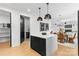 Modern kitchen with stainless steel appliances, quartz countertops, and stylish black lower cabinets at 3256 Brixton Ct, Charlotte, NC 28205