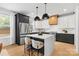 Modern kitchen with stainless steel appliances, quartz countertops, and a stylish center island at 3256 Brixton Ct, Charlotte, NC 28205