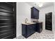 Stylish laundry room with navy cabinets, quartz countertops, and modern washer and dryer at 3256 Brixton Ct, Charlotte, NC 28205
