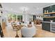 Bright living room featuring an open layout with hardwood floors and access to the outdoor patio at 3256 Brixton Ct, Charlotte, NC 28205