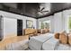 This primary bedroom offers a bright airy feel with black ceiling, natural light, and a stylish accent wall at 3256 Brixton Ct, Charlotte, NC 28205