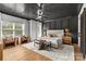 This main bedroom features a dark ceiling, hardwood floors, with large windows and stylish decor at 3256 Brixton Ct, Charlotte, NC 28205