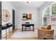 Well-lit home office with a modern desk, comfortable seating, and stylish decor at 3256 Brixton Ct, Charlotte, NC 28205