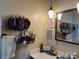 Bathroom featuring a marble countertop, mirror, pendant light, and a decorated wall storage for accessories at 33611 Mann Rd, Albemarle, NC 28001