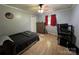 Bedroom featuring hardwood floors, large windows, ceiling fan, neutral color walls, and closet for storage at 33611 Mann Rd, Albemarle, NC 28001