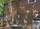 Home exterior with brick foundation, hammock, A/C unit, and wood siding at 33611 Mann Rd, Albemarle, NC 28001
