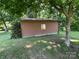 Side of a detached garage on a lush lawn with a small window and surrounded by trees at 33611 Mann Rd, Albemarle, NC 28001