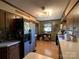 Charming kitchen features wood cabinets, stainless steel refrigerator, butcher block countertops, and natural light at 33611 Mann Rd, Albemarle, NC 28001