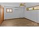 Bedroom with wood flooring, two windows, and a ceiling fan at 376 Oak Tree Rd # 37, Mooresville, NC 28117
