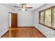 Bedroom with hardwood floors, ceiling fan, and a classic wood door at 376 Oak Tree Rd # 37, Mooresville, NC 28117