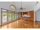 An empty room showcasing hardwood floors, lake views, built in cabinets, and an arched window at 376 Oak Tree Rd # 37, Mooresville, NC 28117