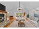 Stylishly furnished living room with stone fireplace, hardwood floors, and seating area facing lake views at 376 Oak Tree Rd # 37, Mooresville, NC 28117