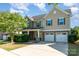 Inviting home featuring stone accents, a two-car garage, and a well-maintained lawn at 3912 Franklin Meadows Dr, Matthews, NC 28105