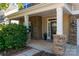 Welcoming front porch featuring stone pillars and accents, providing a charming entrance to the home at 3912 Franklin Meadows Dr, Matthews, NC 28105