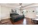 Spacious bedroom featuring hardwood floors, a ceiling fan, and exercise equipment for convenience at 3912 Franklin Meadows Dr, Matthews, NC 28105