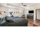 Spacious bedroom featuring hardwood floors, a ceiling fan, and exercise equipment for convenience at 3912 Franklin Meadows Dr, Matthews, NC 28105
