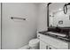 Modern bathroom featuring a white vanity with dark countertop and a tiled shower at 500 Dedmon Dr, Charlotte, NC 28216