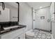Modern bathroom showcasing marble countertops, black hardware, and glass-enclosed shower at 500 Dedmon Dr, Charlotte, NC 28216