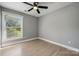 Bedroom featuring a modern ceiling fan, natural light from a window, and light wood floors at 500 Dedmon Dr, Charlotte, NC 28216