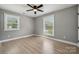 Cozy bedroom featuring hardwood floors and plenty of natural light from two windows at 500 Dedmon Dr, Charlotte, NC 28216