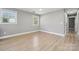 Cozy bedroom featuring sleek flooring, neutral paint, and multiple windows for natural light at 500 Dedmon Dr, Charlotte, NC 28216