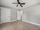 Comfortable bedroom with ceiling fan, light walls, and hardwood floors at 500 Dedmon Dr, Charlotte, NC 28216
