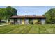 Charming home featuring a well manicured lawn, a yellow front door, and lovely landscaping at 500 Dedmon Dr, Charlotte, NC 28216
