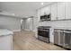 Bright kitchen area showcasing stainless steel appliances and light wood floors at 500 Dedmon Dr, Charlotte, NC 28216