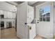 Updated kitchen with stainless steel appliances, a laundry area, and access to backyard at 500 Dedmon Dr, Charlotte, NC 28216