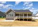 Charming home exterior featuring a covered back porch and a neatly maintained lawn at 5162 Beckenham Ln, Concord, NC 28025