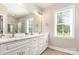 Elegant bathroom featuring double sinks, granite countertops, and a frameless glass shower at 5162 Beckenham Ln, Concord, NC 28025